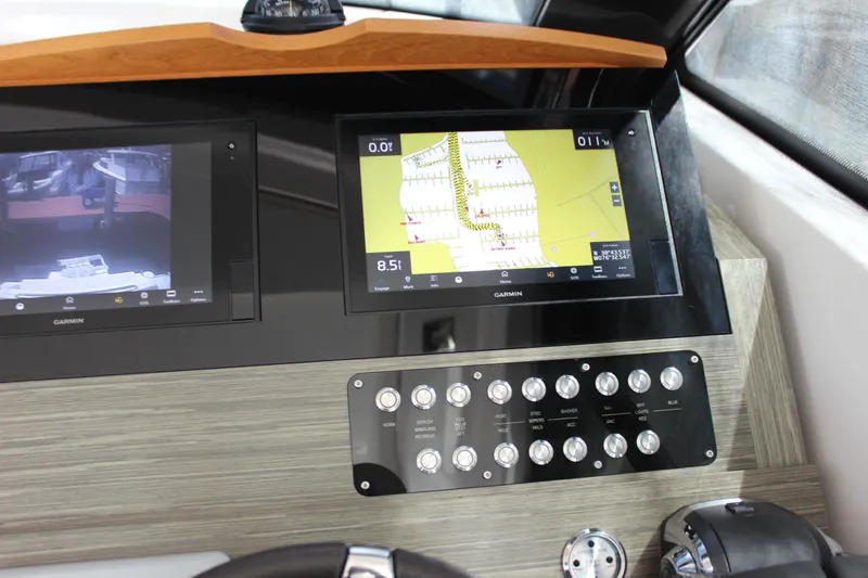Slide: The Image of Helm of 2019 Tiara Yachts C39 Coupe featuring Garmin navigation displays and control panel. - 23