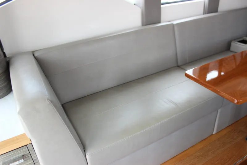 Slide: The Image of Luxurious interior seating of 2019 Tiara Yachts C39 Coupe with sleek wooden table. - 62