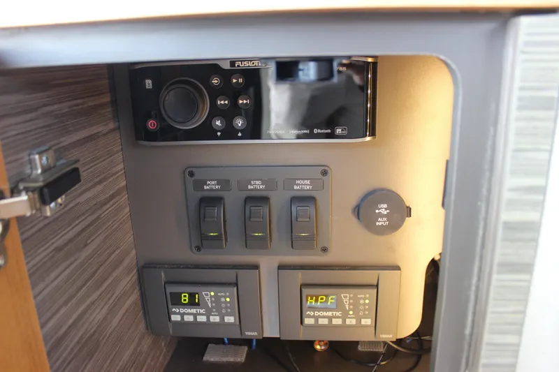 Slide: The Image of Control panel of 2019 Tiara Yachts C39 Coupe with battery switches and audio system. - 57