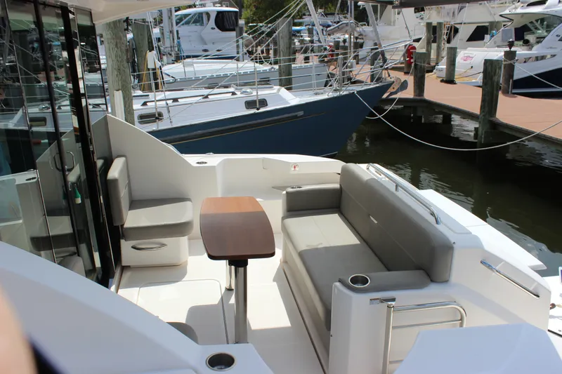 Slide: The Image of 2019 Tiara Yachts C39 Coupe cockpit with seating and table, docked at marina. - 29