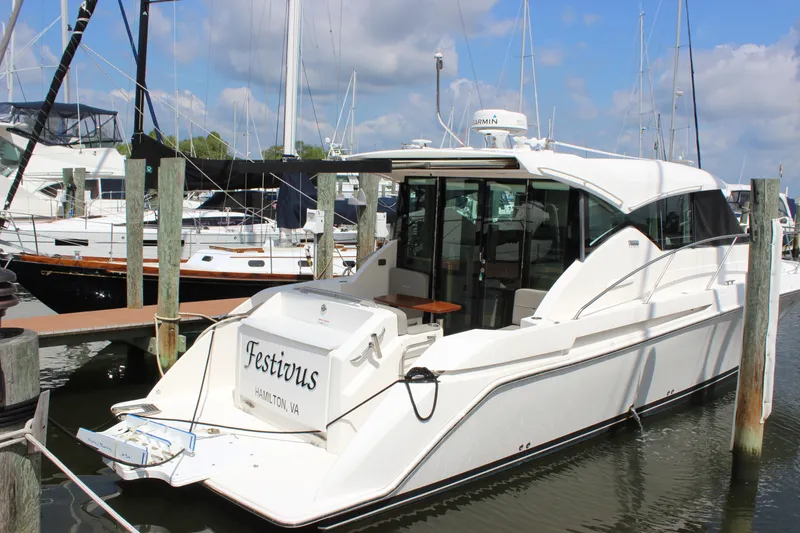 Slide: The Image of 2019 Tiara Yachts C39 Coupe docked at marina, featuring sleek design and spacious deck. - 34