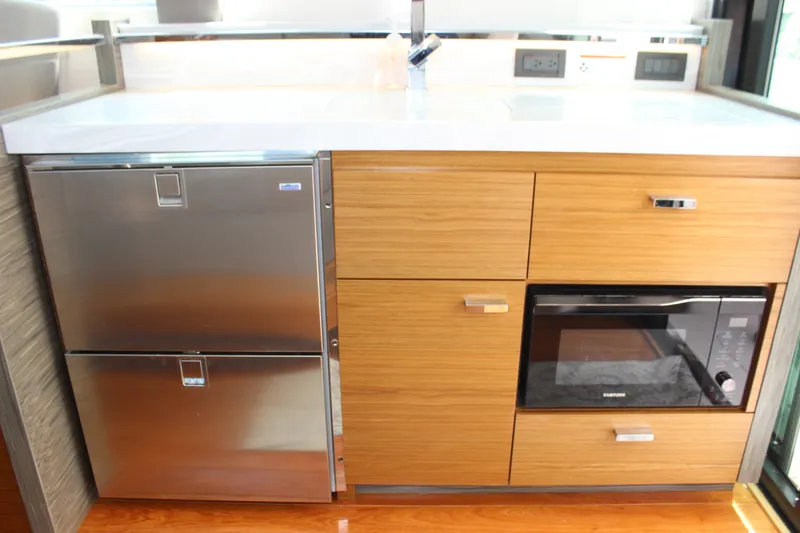 Slide: The Image of Modern kitchen area in 2019 Tiara Yachts C39 Coupe with stainless steel appliances. - 56