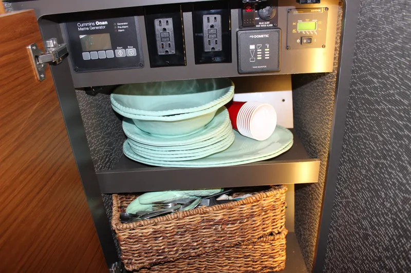 Slide: The Image of Cabinet in 2019 Tiara Yachts C39 Coupe with plates, cups, and generator controls. - 87