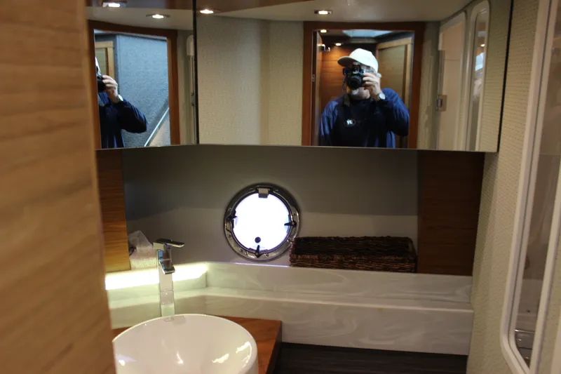 Slide: The Image of Modern bathroom interior of 2019 Tiara Yachts C39 Coupe with round porthole and sleek fixtures. - 82