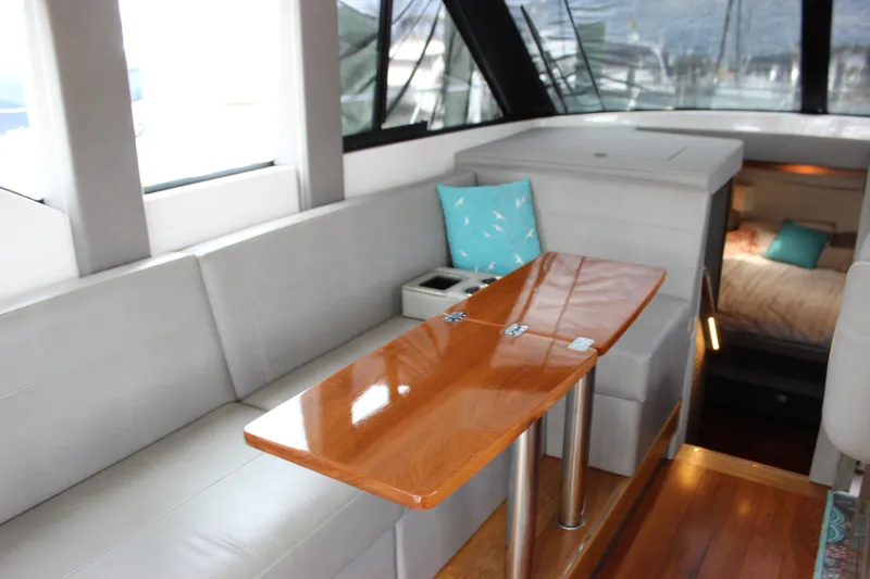 Slide: The Image of Interior of 2019 Tiara Yachts C39 Coupe with sleek seating and wooden table. - 63