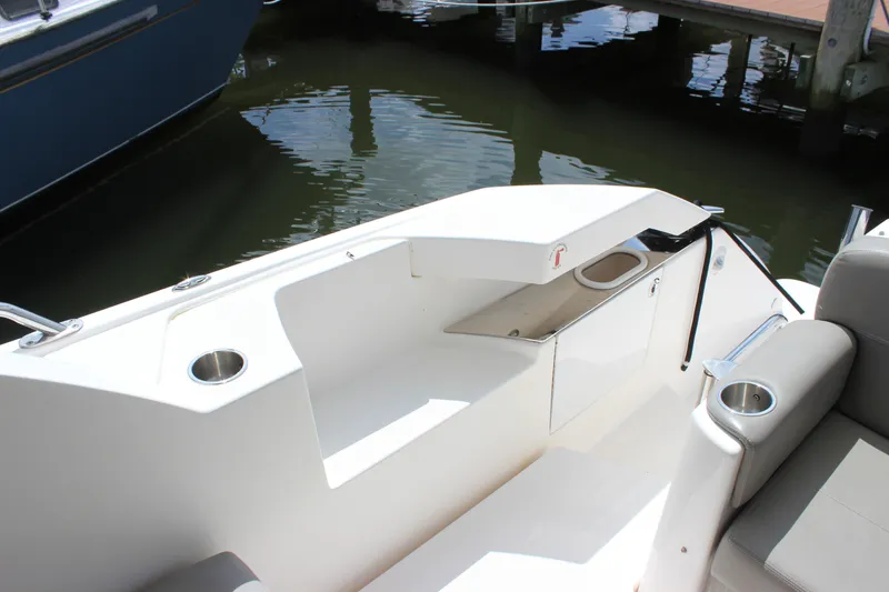 Slide: The Image of 2019 Tiara Yachts C39 Coupe cockpit with seating and cup holders by the dock. - 104