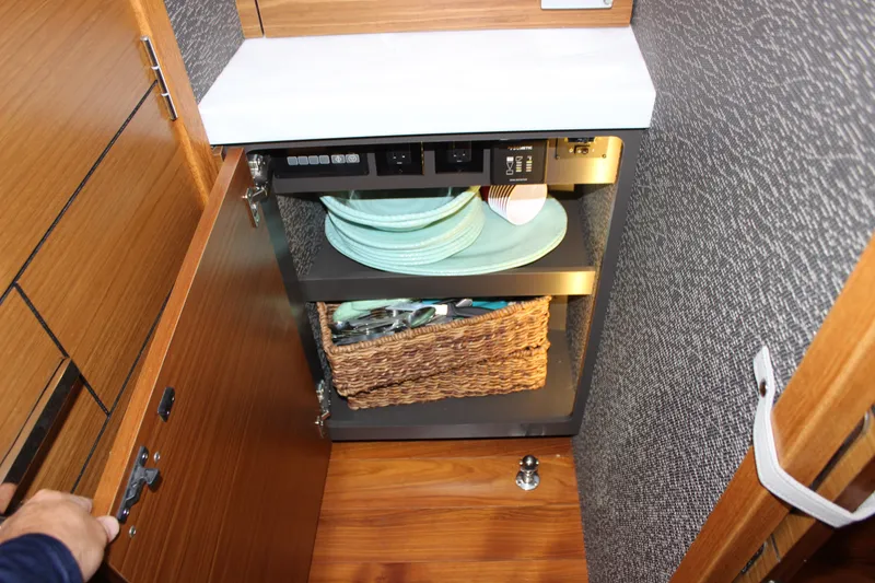 Slide: The Image of Cabinet interior on 2019 Tiara Yachts C39 Coupe with plates and basket. - 86
