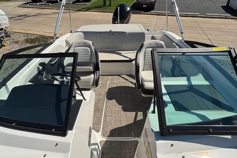 Slide: The Image of 2021 Sea Ray SPX 190 Outboard boat interior with seating and steering wheel. - 22