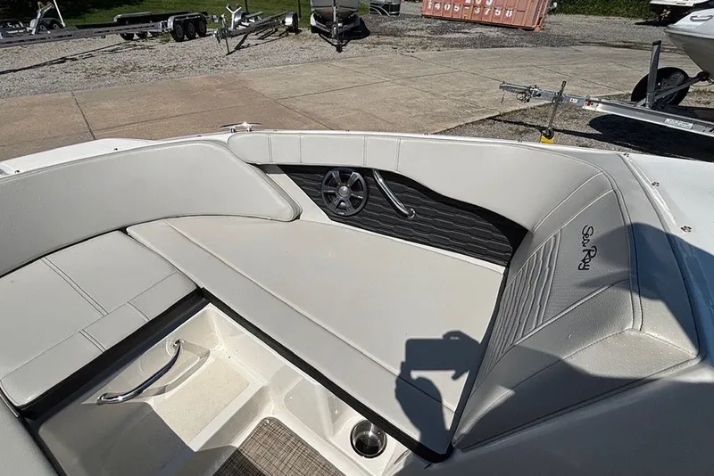 Slide: The Image of 2021 Sea Ray SPX 190 Outboard boat interior with white seating and speaker detail. - 19