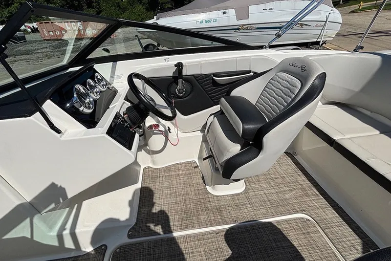 Slide: The Image of 2021 Sea Ray SPX 190 Outboard boat interior with steering wheel and seating. - 13