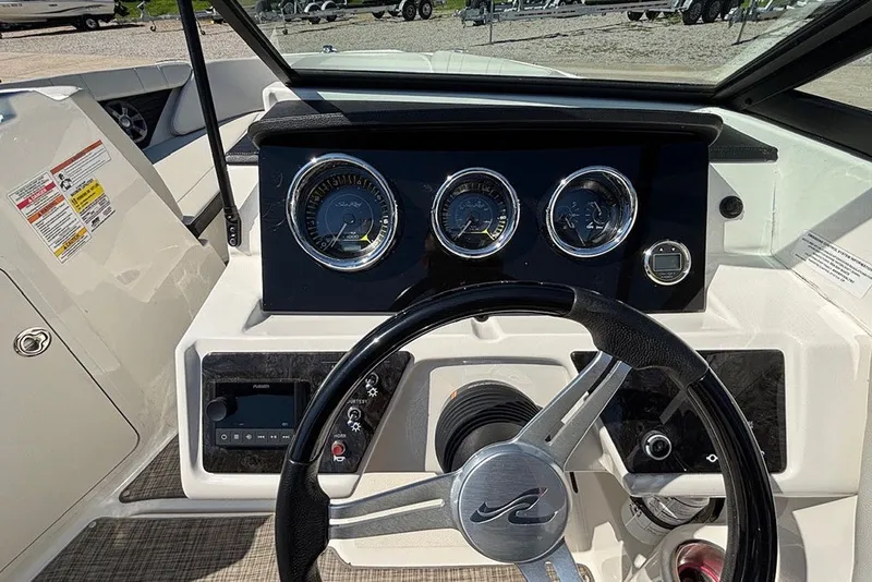 Slide: The Image of 2021 Sea Ray SPX 190 Outboard dashboard with steering wheel and gauges. - 14