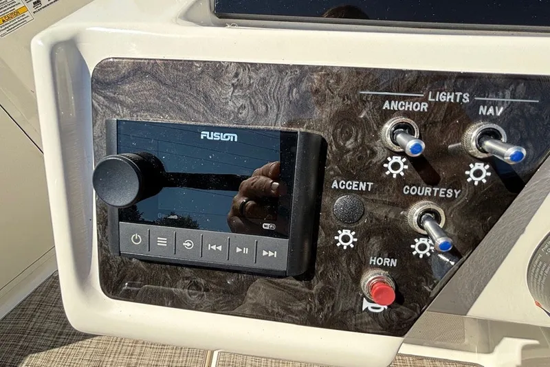 Slide: The Image of Control panel of 2021 Sea Ray SPX 190 Outboard with Fusion audio system and switches. - 17
