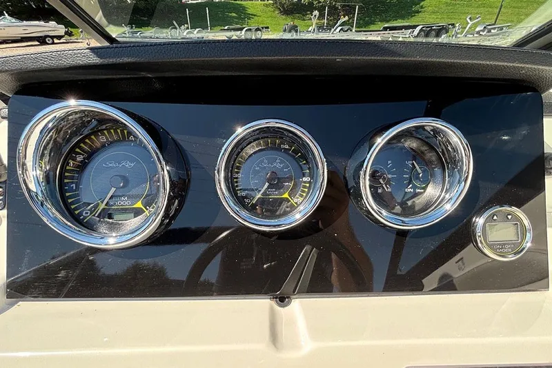 Slide: The Image of Dashboard of 2021 Sea Ray SPX 190 Outboard with chrome-trimmed gauges. - 15