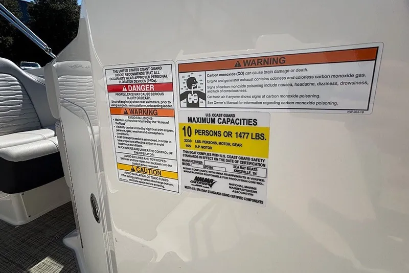 Slide: The Image of 2021 Sea Ray SPX 190 Outboard safety warnings and capacity labels on boat interior. - 21