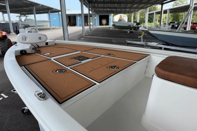 Slide: The Image of 2027 Avid 19 FSX boat with tan deck, under covered storage. - 20