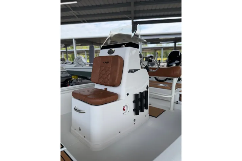 Slide: The Image of 2027 Avid 19 FSX boat console with brown cushioned seating and modern design. - 19