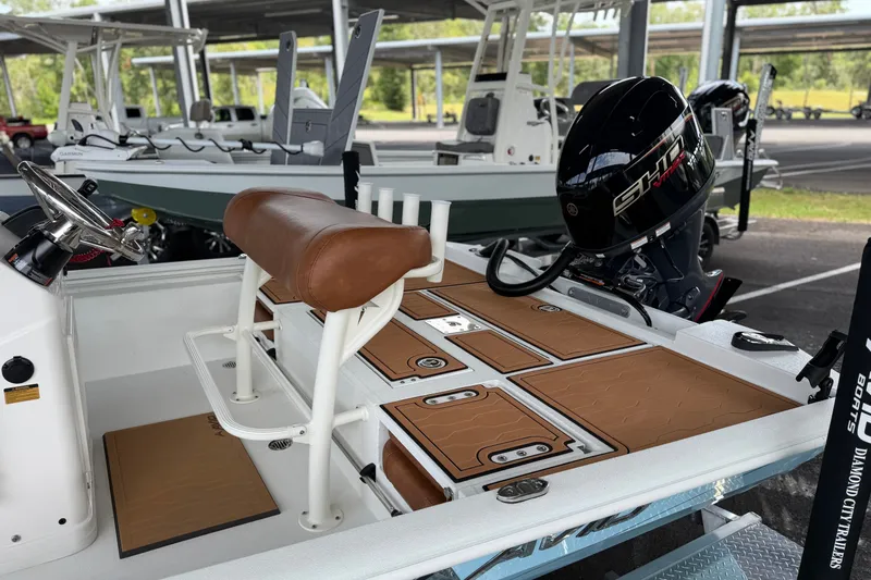 Slide: The Image of 2027 Avid 19 FSX boat with brown seating and powerful outboard motor. - 17