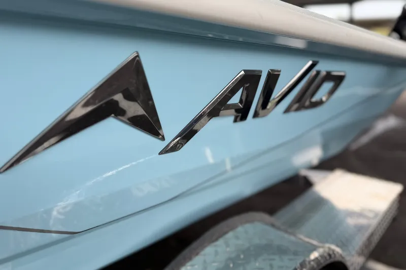 Slide: The Image of Close-up of 2027 Avid 19 FSX boat logo on light blue hull. - 14