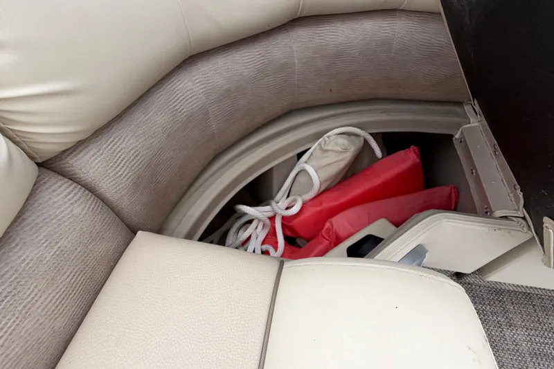 Slide: The Image of Storage compartment in 2015 Bennington 2550 RSR boat with life jackets and rope. - 38