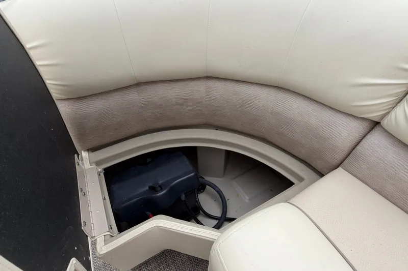 Slide: The Image of Storage compartment in 2015 Bennington 2550 RSR boat with cushioned seating. - 30