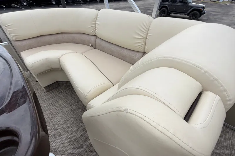 Slide: The Image of Luxurious seating on a 2015 Bennington 2550 RSR pontoon boat, featuring beige upholstery. - 21