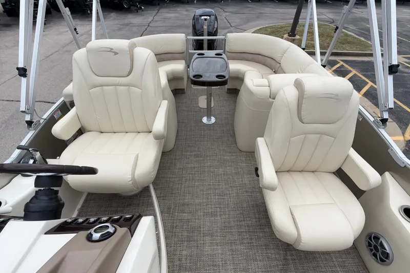 Slide: The Image of 2015 Bennington 2550 RSR boat interior with plush seating and steering console. - 24