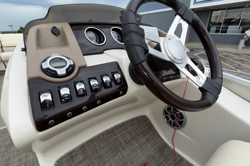 Slide: The Image of Steering console of 2015 Bennington 2550 RSR boat with controls and gauges. - 42