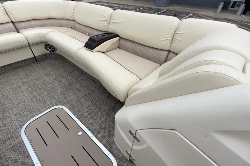 Slide: The Image of Luxurious seating on a 2015 Bennington 2550 RSR pontoon boat with beige upholstery. - 26