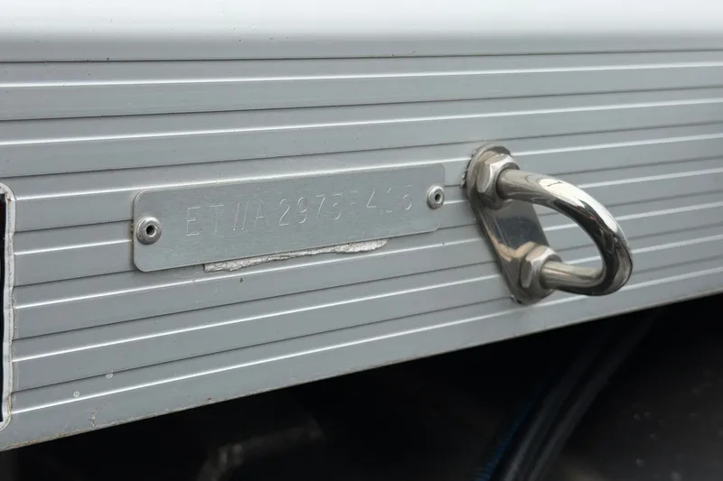 Slide: The Image of Close-up of a 2015 Bennington 2550 RSR boat's identification plate and metal cleat. - 46