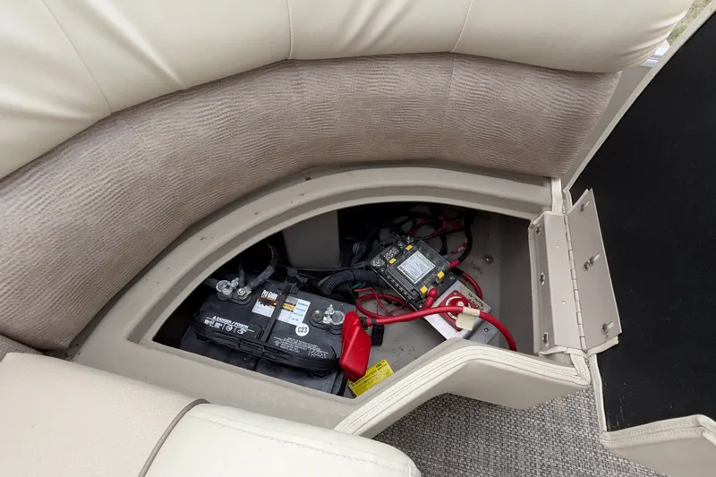 Slide: The Image of Battery compartment of a 2015 Bennington 2550 RSR boat, showing wiring and connections. - 31