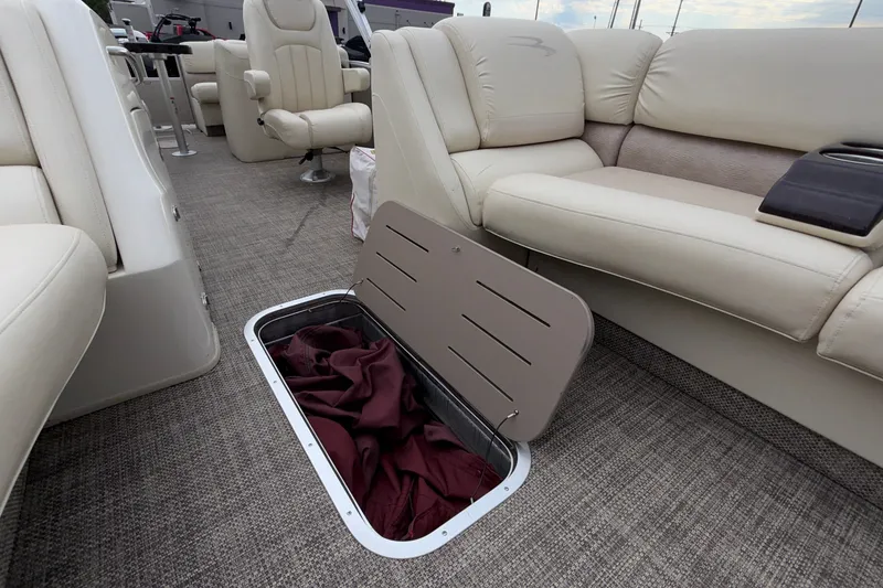 Slide: The Image of Interior of 2015 Bennington 2550 RSR boat with open storage compartment. - 39