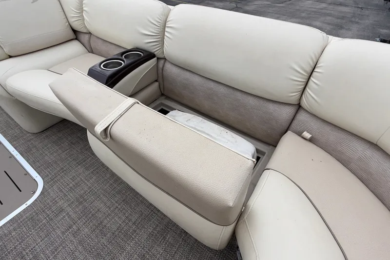 Slide: The Image of Bennington 2550 RSR 2015 boat interior with beige seating and cup holders. - 36