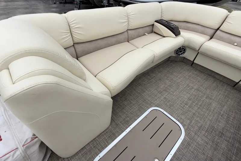 Slide: The Image of Luxurious seating on a 2015 Bennington 2550 RSR pontoon boat with beige upholstery. - 25