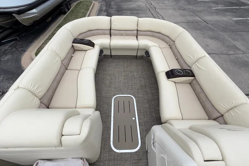 Slide: The Image of Luxurious seating on a 2015 Bennington 2550 RSR pontoon boat, featuring plush beige upholstery. - 27