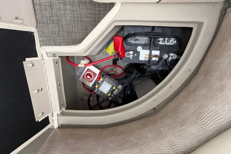 Slide: The Image of Battery compartment of a 2015 Bennington 2550 RSR boat, showing wiring and connections. - 45
