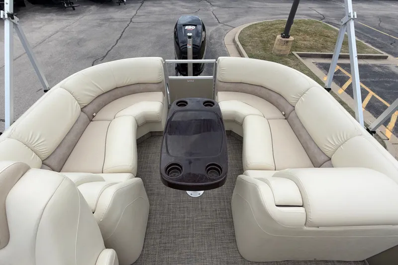 Slide: The Image of Luxurious seating on a 2015 Bennington 2550 RSR pontoon boat with a central table. - 19