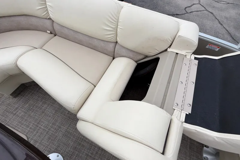 Slide: The Image of 2015 Bennington 2550 RSR boat interior with beige seating and carpeted flooring. - 40