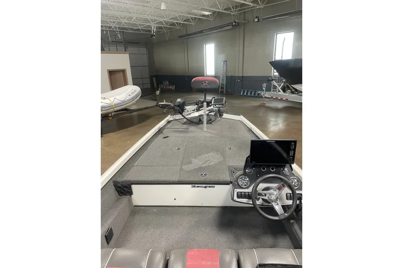 Slide: The Image of 2019 Ranger RT188 boat interior with steering wheel and control panel in a showroom. - 11