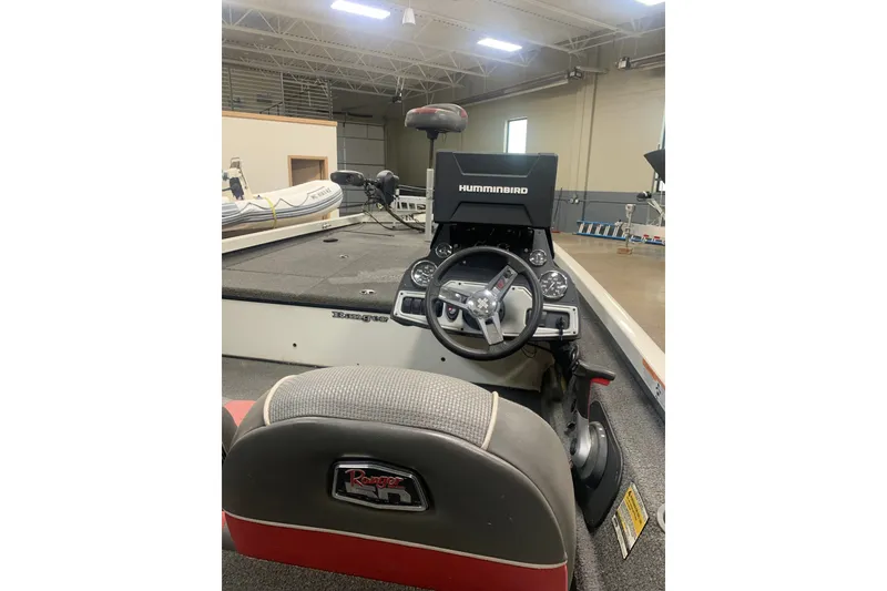 Slide: The Image of 2019 Ranger RT188 boat interior with Humminbird electronics and steering wheel in showroom. - 8
