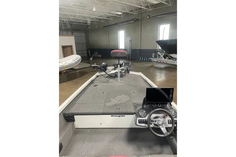 Slide: The Image of 2019 Ranger RT188 boat interior with steering wheel and control panel in a showroom. - 12