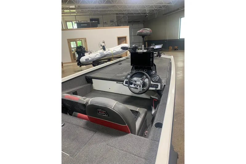 Slide: The Image of 2019 Ranger RT188 boat interior with steering wheel and dashboard in a showroom. - 10