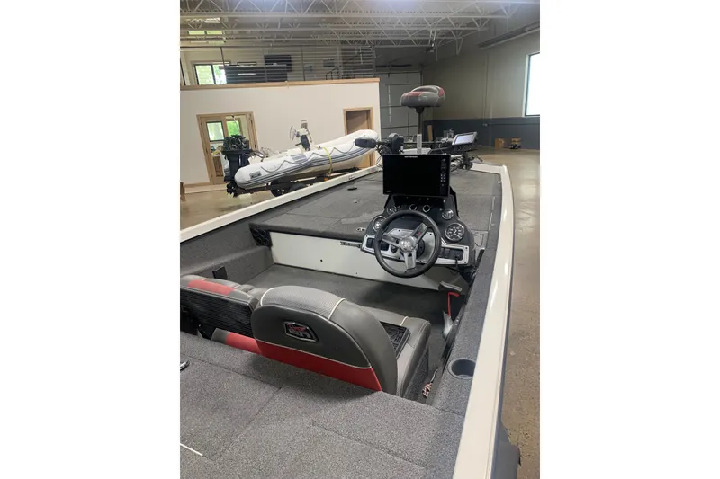 Slide: The Image of 2019 Ranger RT188 boat interior with steering wheel and dashboard in a showroom. - 9
