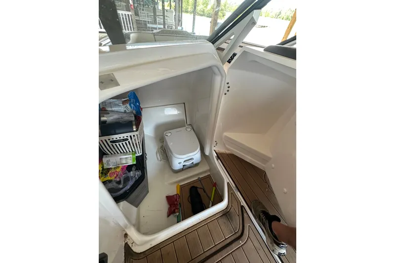 Slide: The Image of Storage compartment in 2023 Yamaha Boats 275SDX, featuring organized supplies and equipment. - 7