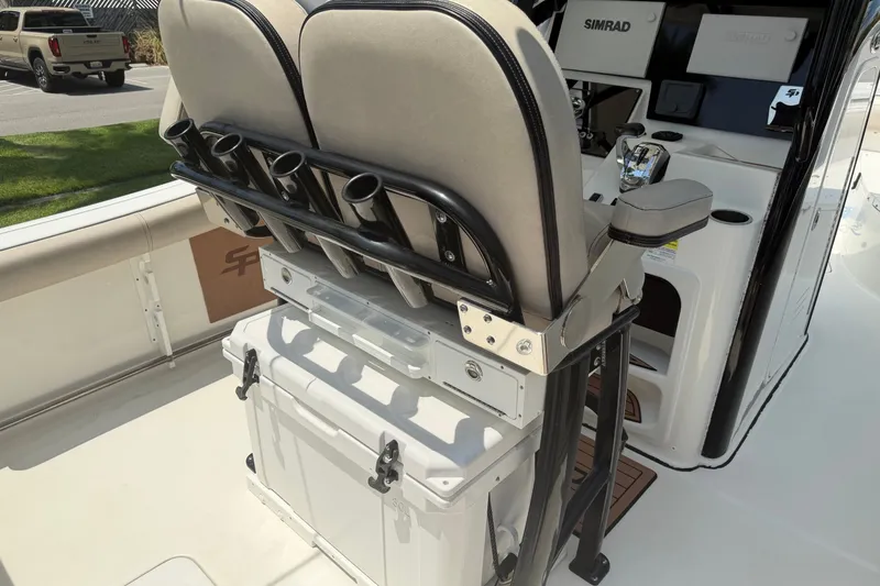 Slide: The Image of 2020 Sea Pro 239 Center Console boat interior with rod holders and Simrad electronics. - 14