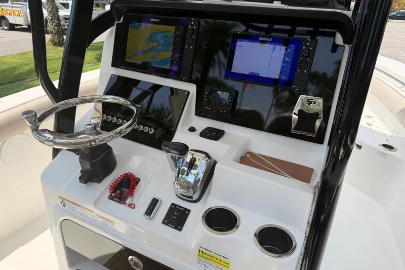 Slide: The Image of 2020 Sea Pro 239 Center Console boat dashboard with navigation screens and controls. - 19