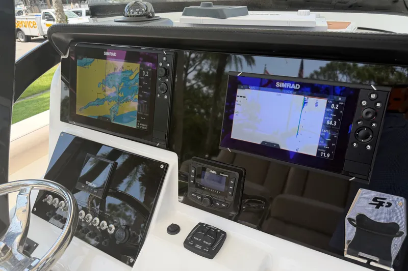 Slide: The Image of 2020 Sea Pro 239 Center Console dashboard with Simrad navigation displays. - 18