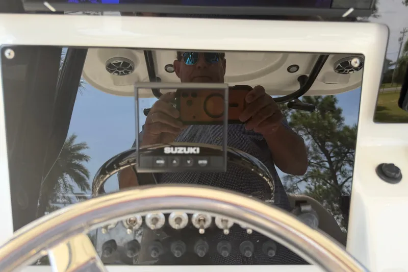 Slide: The Image of Reflection on Sea Pro 239 Center Console dashboard with Suzuki display, 2020 model. - 20