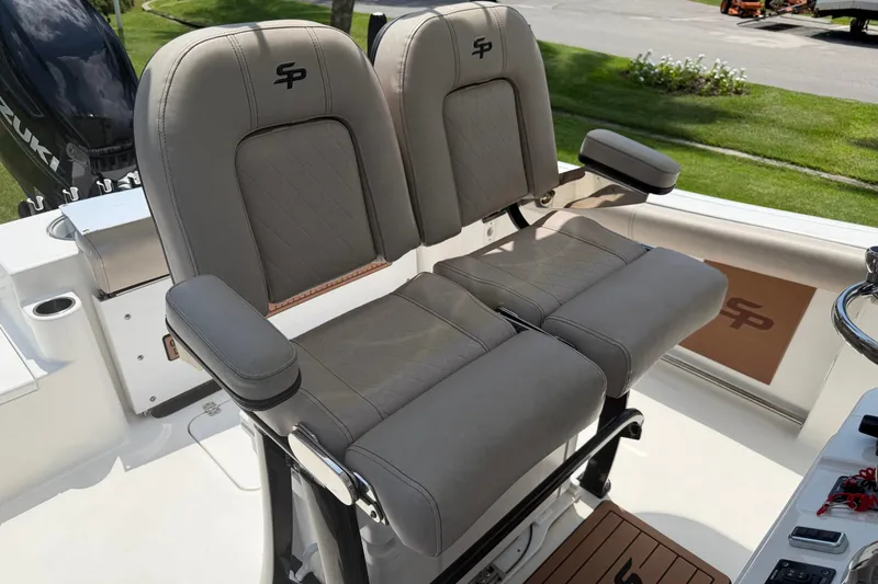 Slide: The Image of 2020 Sea Pro 239 Center Console boat seats with armrests and logo, featuring a Suzuki engine. - 16