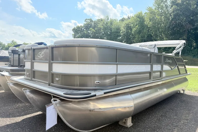 The Image of 2027 Bentley Pontoons Legacy 223 Swingback pontoon boat on display outdoors. - 1
