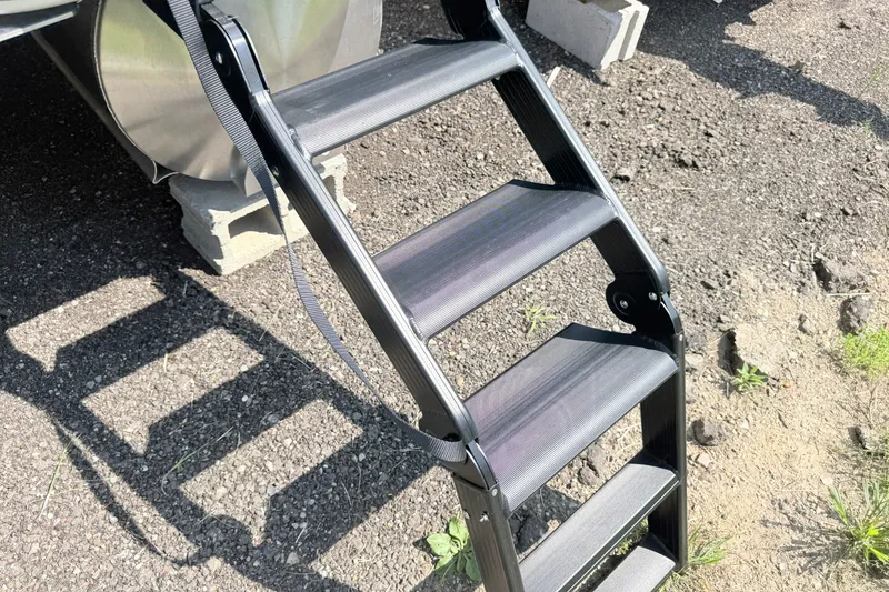 Slide: The Image of Ladder of 2027 Bentley Pontoons Legacy 223 Swingback on gravel surface. - 19